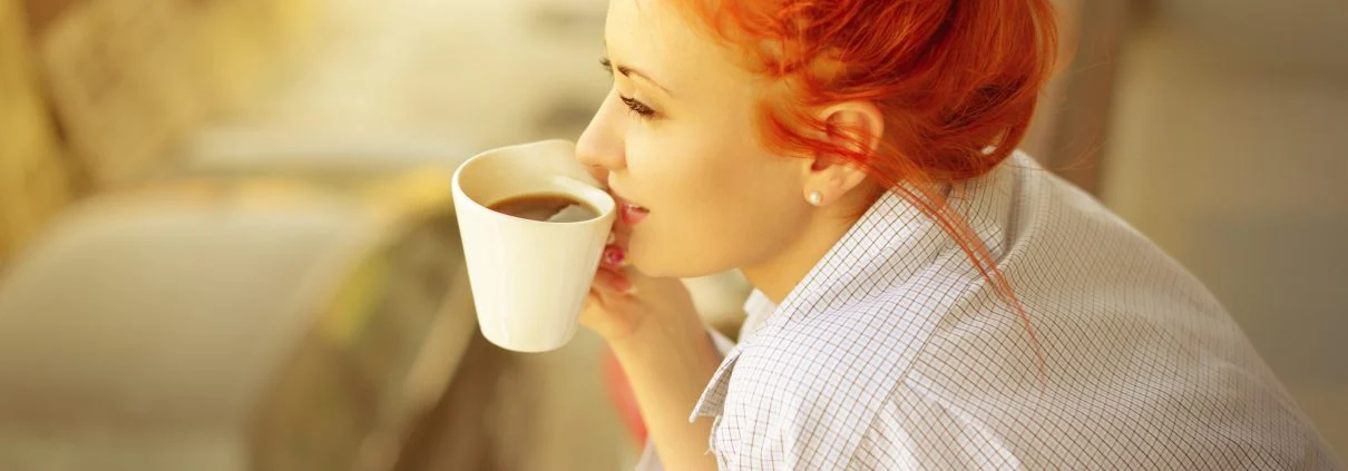 good morning womans with cup of fragrant coffee on balcony